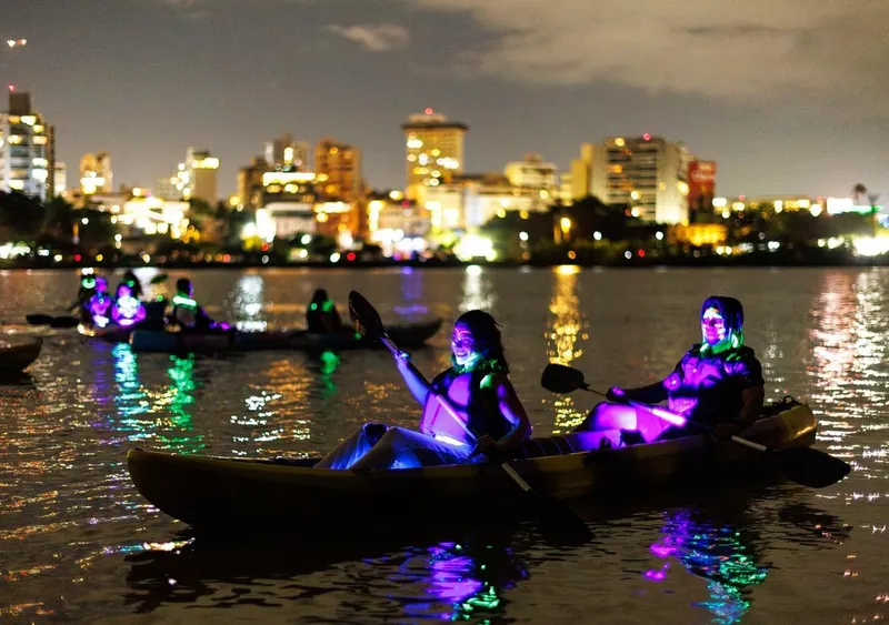 Glowing kayak under the stars on the Condado Lagoon before a beach salsa experience on a night glow kayak tour in San Juan, Puerto Rico